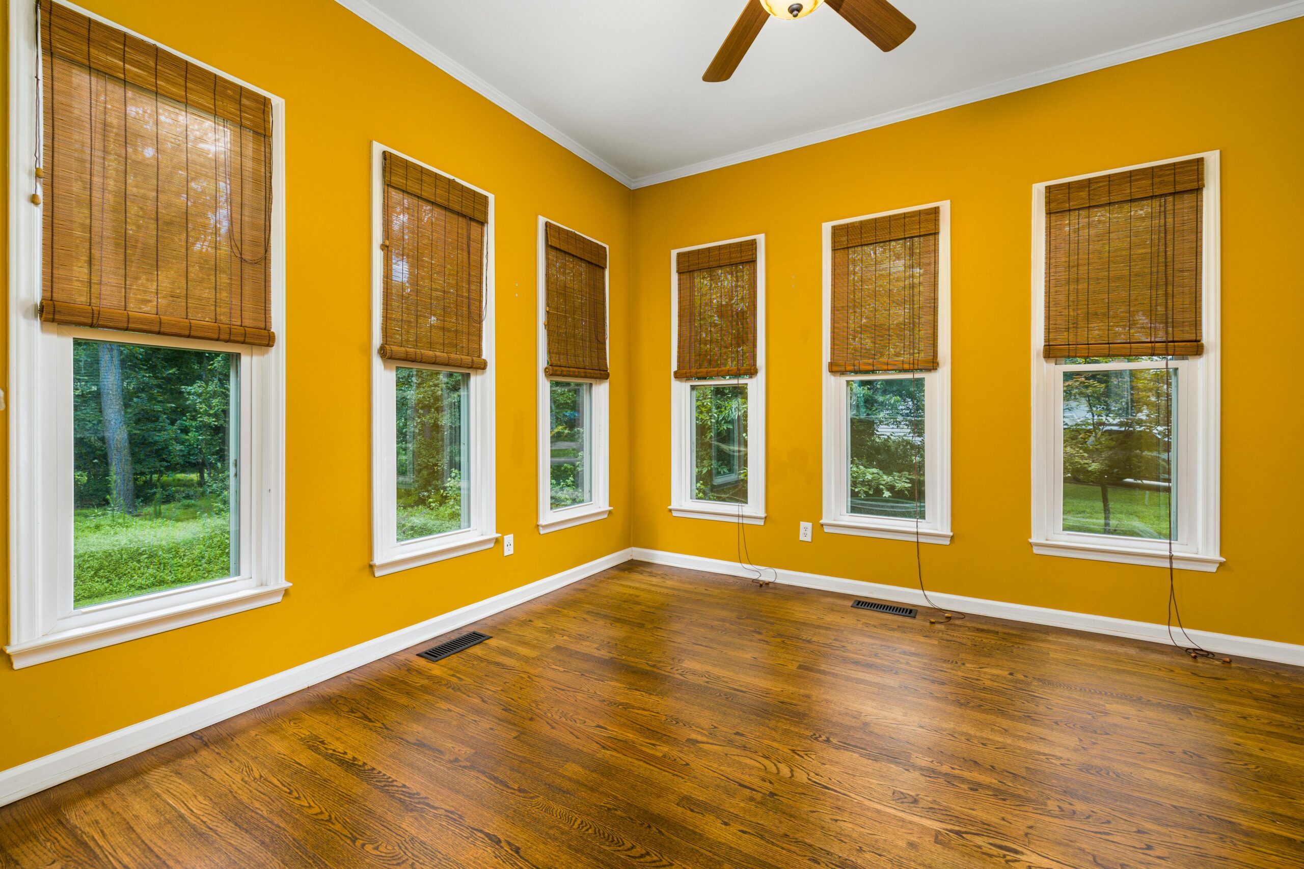 White wooden framed glass windows on yellow wall